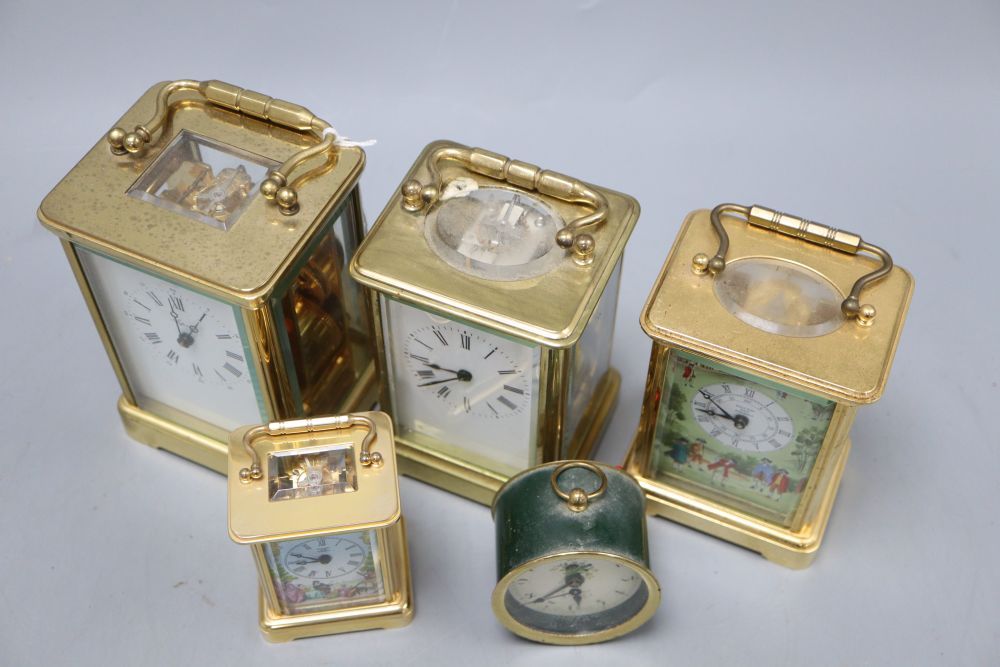 An Asprey brass cased carriage clock, another carriage clocks, two Halcyon Days carriage timepieces and an alarm clock, tallest 14cm (h